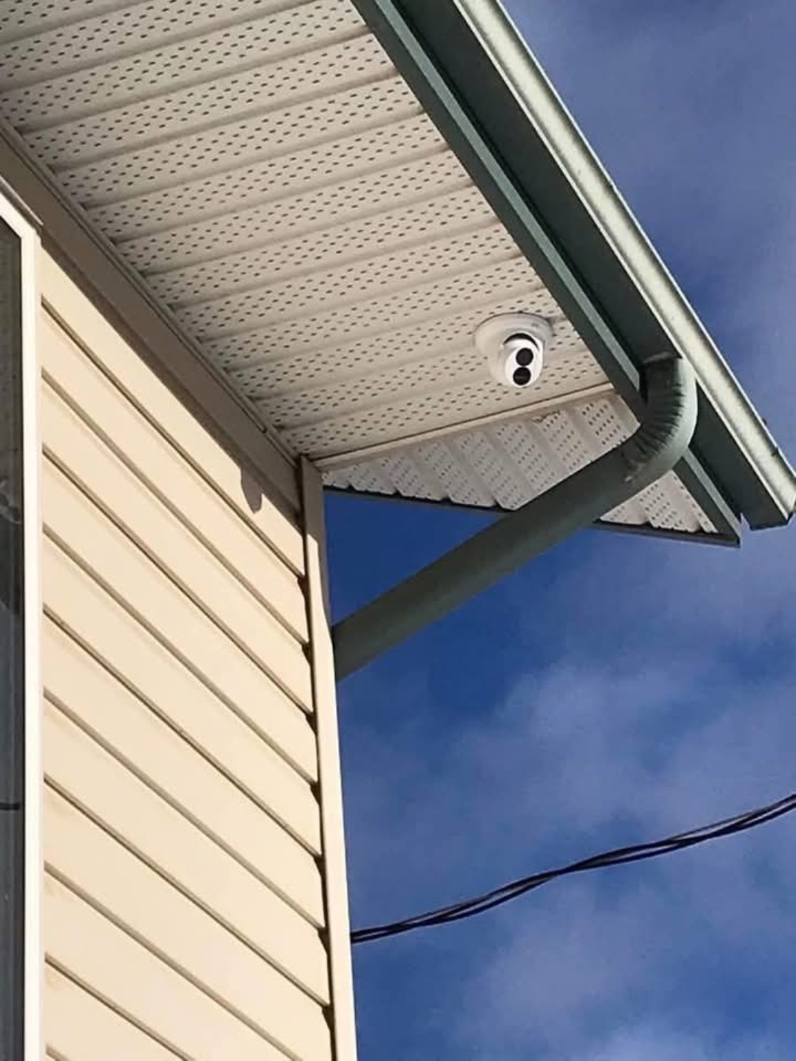 Security camera installed beneath a residential soffit